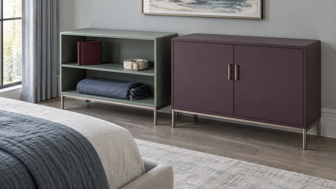 Sage open shelving displays an album, woven belt, and folded shawl beside a plum cabinet with closed opaque doors in a bedroom.